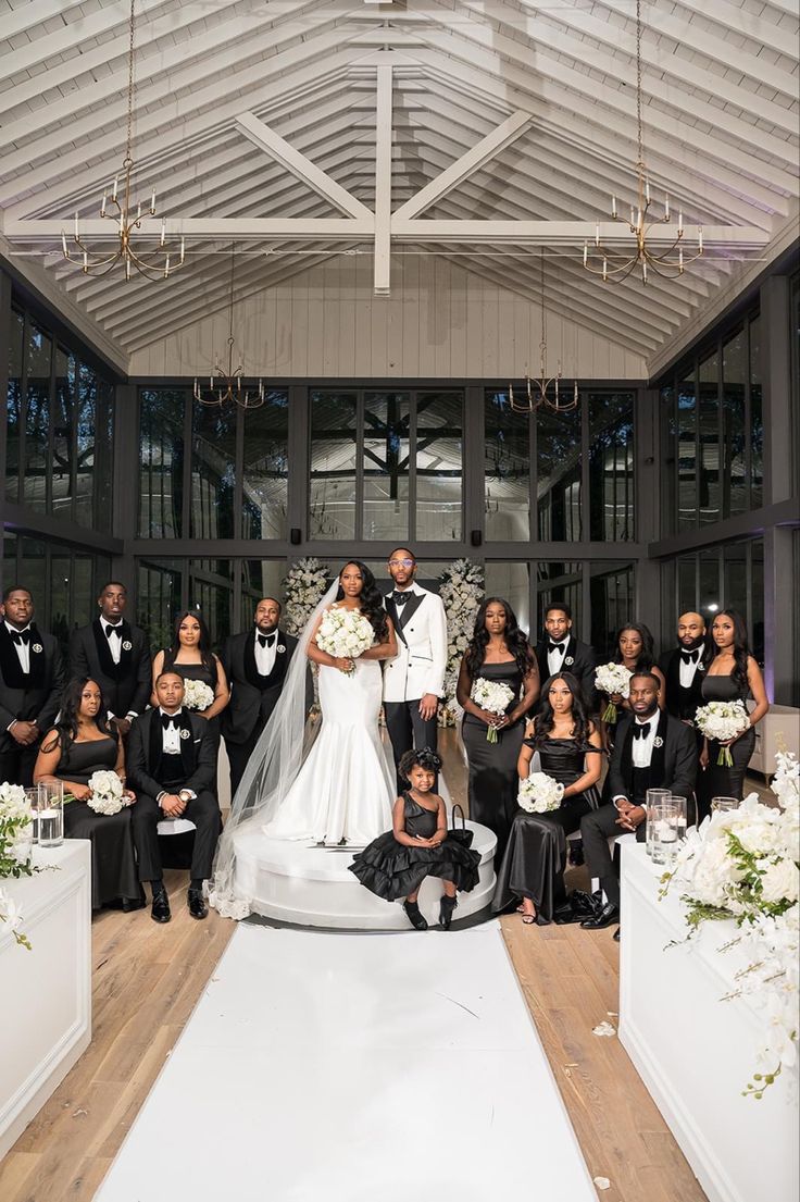 a bride and groom posing with their wedding party