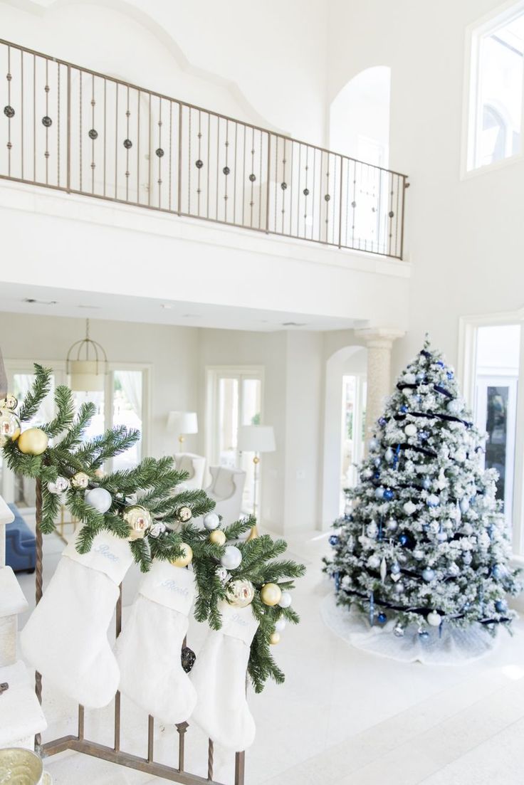 a living room filled with furniture and a christmas tree