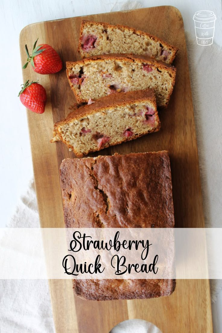 strawberry quick bread on a cutting board with strawberries