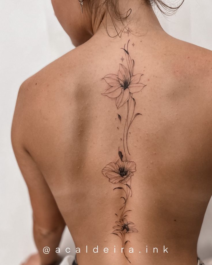 the back of a woman's neck with flowers on it