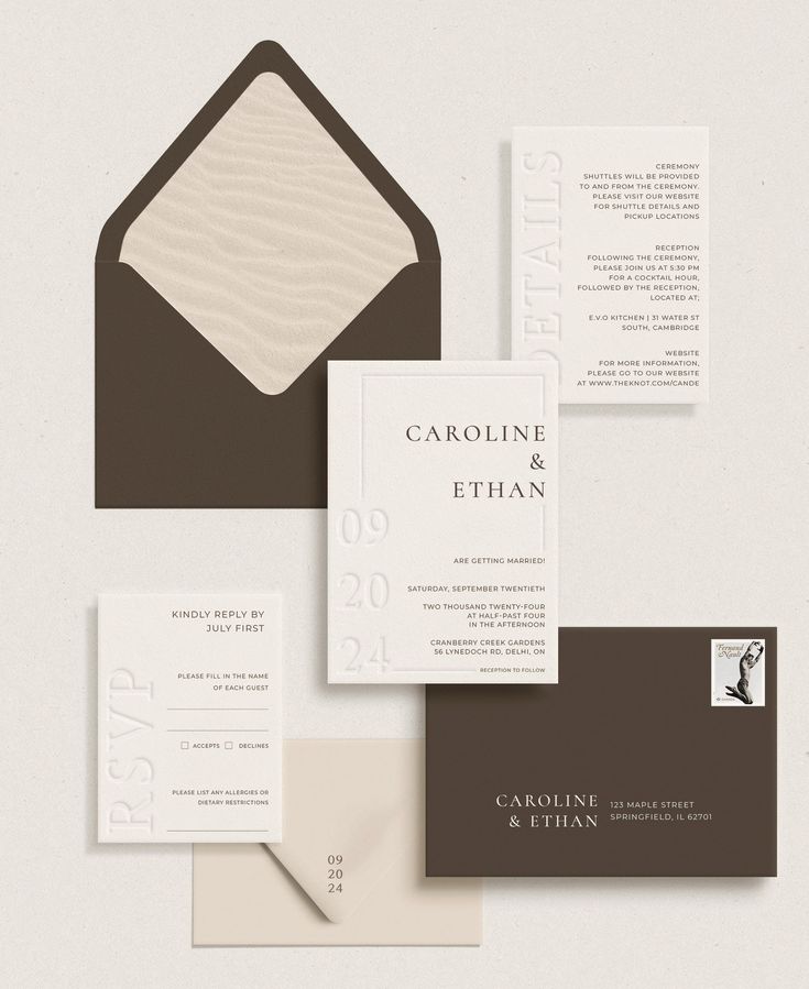 the stationery is laid out on top of each other, including an envelope and business cards