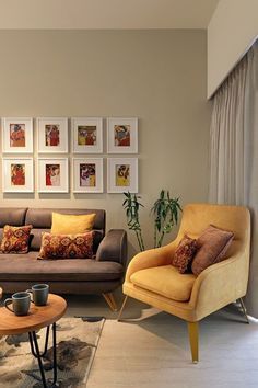 a living room with couches, chairs and pictures on the wall in it's corner