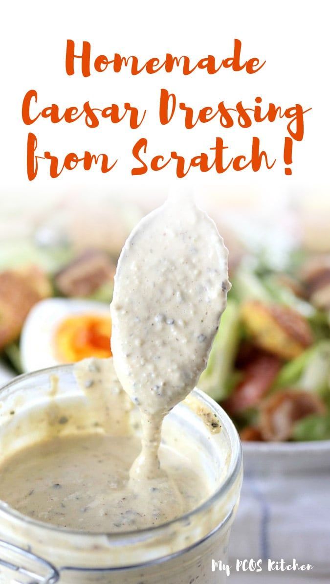 homemade caesar dressing from scratch recipe in a glass jar with a spoon full of dressing