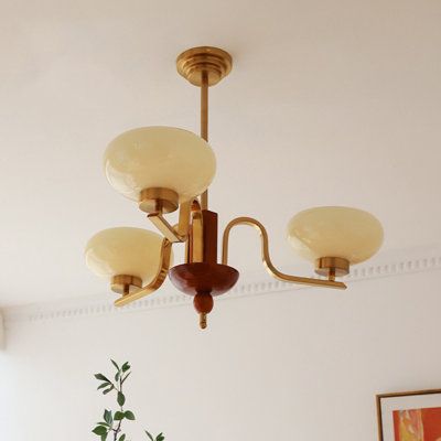 a chandelier hanging from the ceiling in a living room