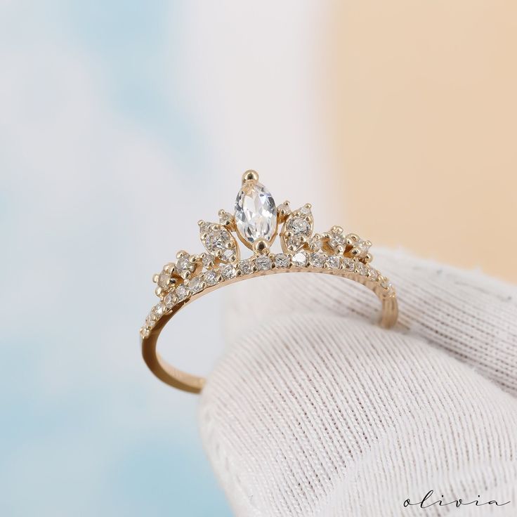 a diamond ring sitting on top of a white cloth