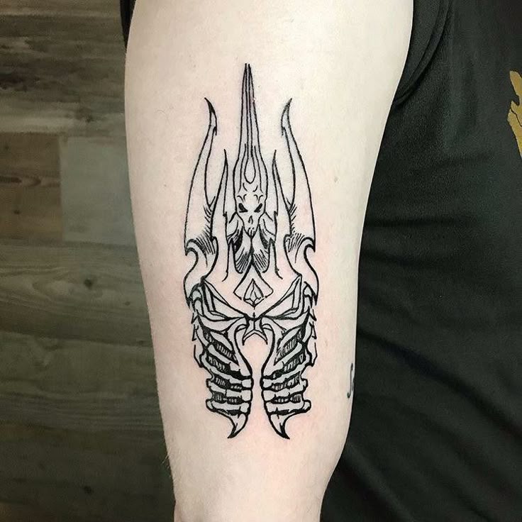 a man with a tattoo on his arm that has a skeleton in the shape of a lobster