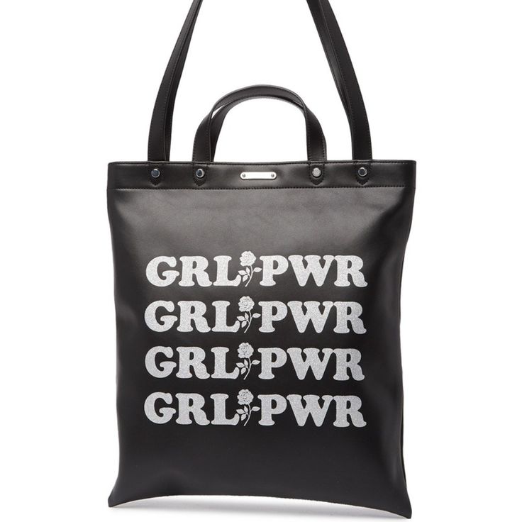 Empowering Messages Are Emblazoned On A Handy Tote Created From Edgy Leather To Create A Statement Wherever You Go. - Dual Top Handles - Dual Top Shoulder Straps - Open Top - Exterior Features Print Details - Interior Features 1 Zip Pocket - Approx. 15" H X 13.5" W X 1" D - Approx. 3.5" Handle Drop, 11.5" Strap Drop - Materials: Leather Black Double Handle Bag With Logo Hardware, Black Top Handle Bag With Logo Hardware, Black Tote Bag With Logo Hardware, Black Leather Shoulder Bag With Logo, Leather Tote Shoulder Bag With Logo Hardware, Black Leather Bag With Logo Hardware, Casual Leather Bag With Logo, Trendy Leather Shoulder Bag With Logo Hardware, Chic Black Shoulder Bag With Logo Hardware