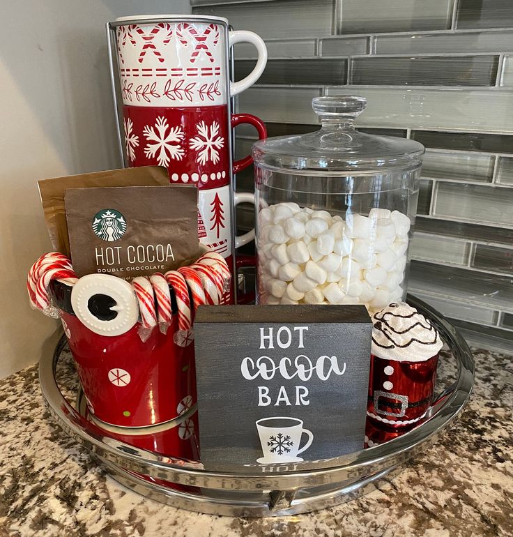 hot cocoa bar with candy, marshmallows and coffee mugs