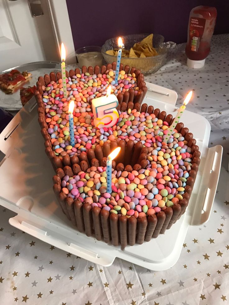 a heart shaped cake with lit candles on it