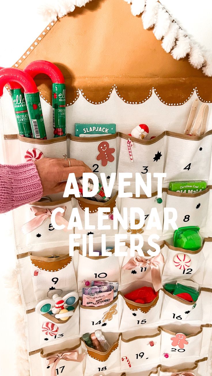 a calendar is hanging on a wall with scissors and other items in it that are labeled'advent calendar fillers '