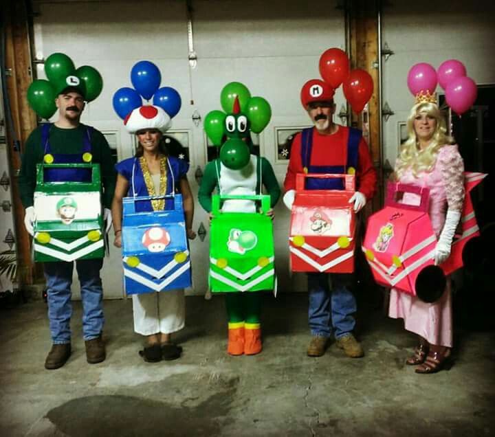 some people are dressed up as mario and luigi the frog with balloons on their heads