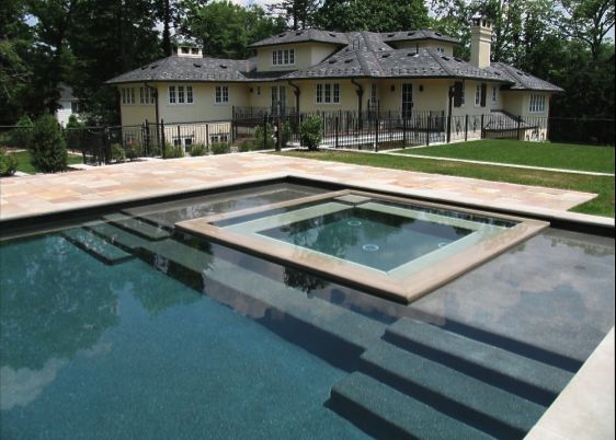 a house with a pool in front of it