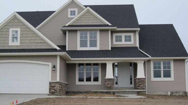 a large house with two garages in the front and one on the other side