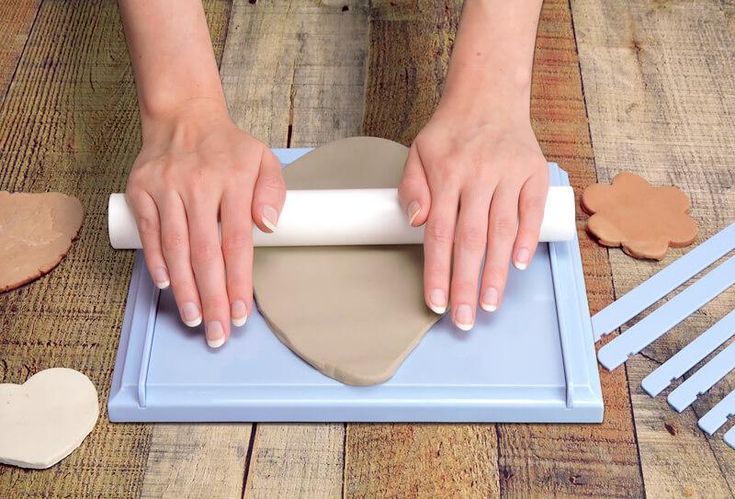 a woman is making heart shaped cookies with her hands