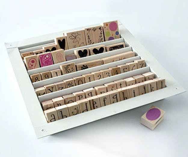 a wooden typewriter sitting on top of a table next to a rubber stamp pad