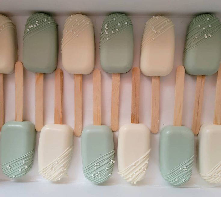 a box filled with lots of green and white pops