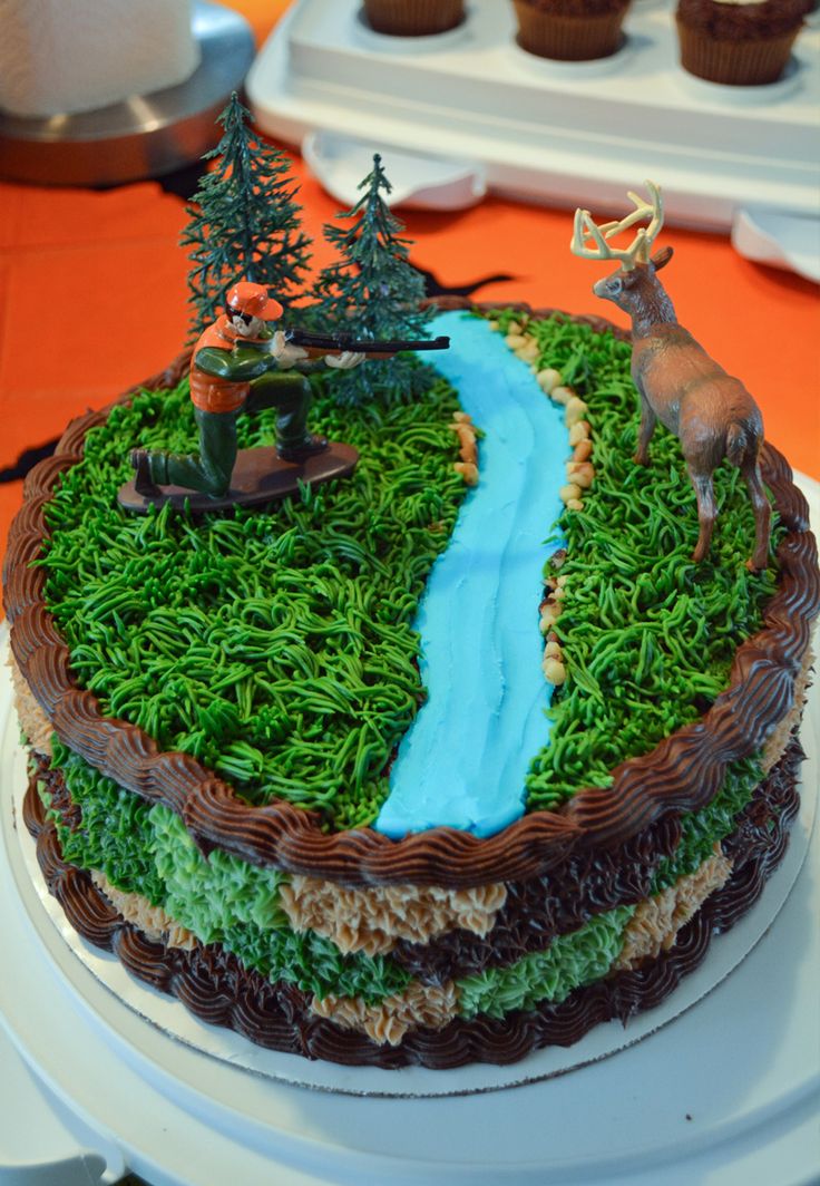 there is a cake with grass and trees on it