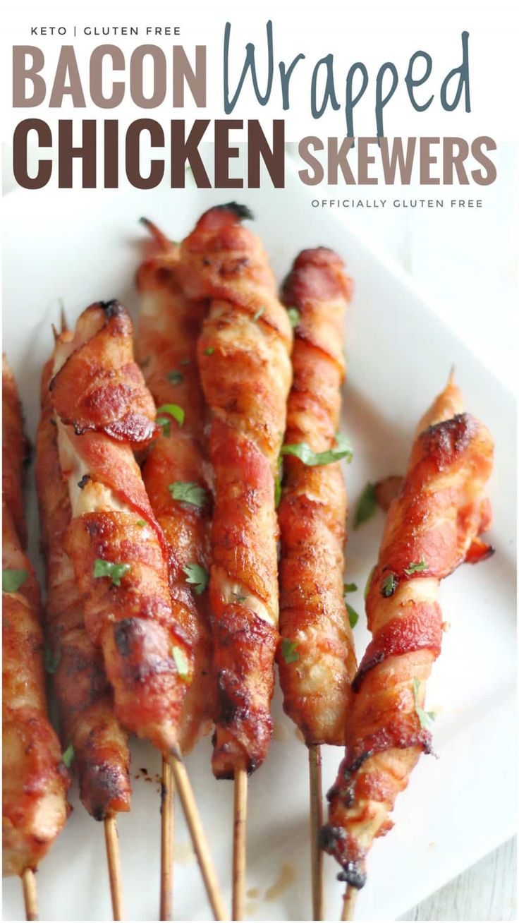 bacon wrapped chicken skewers on a white plate