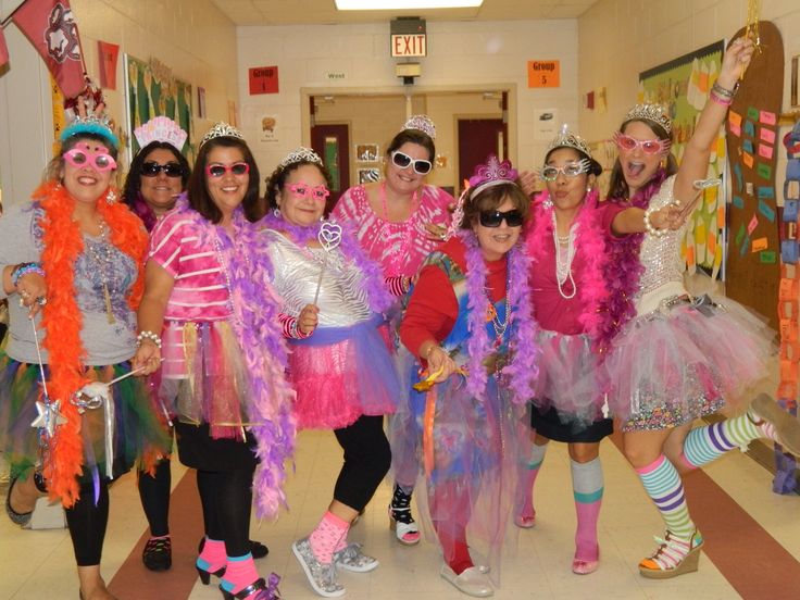 a group of women in costumes posing for a photo