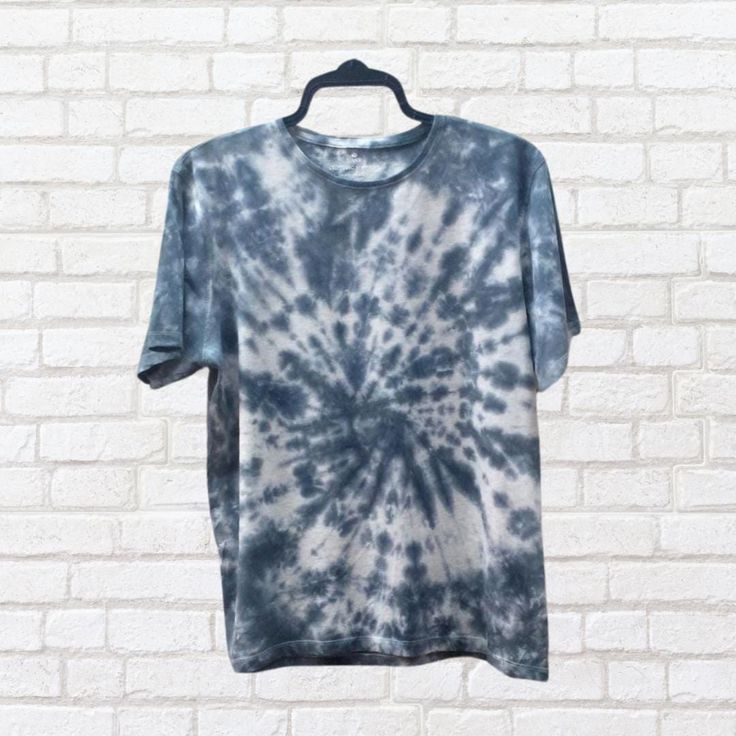 Expertly hand-dyed in a striking black tie dye design, this men's sustainable 100% cotton shirt is both unique and stylish.  Made from high-quality materials and dyed using eco-reactive dyes, it offers comfort and style while reducing environmental impact.  Upgrade your wardrobe with this one-of-a-kind piece. Relaxed Fit Tie-dye T-shirt With Natural Dye, Casual Black Pre-washed T-shirt, Natural Dye Tie-dye Cotton Tops, Cotton Tie-dye Top With Natural Dye, Acid Wash Cotton T-shirt With Natural Dye, Cotton Tie Dye Tops With Natural Dye, Tie Dye Cotton Top With Natural Dye, Pre-washed Tie Dye T-shirt With Crew Neck, Pre-washed Tie Dye T-shirt For Summer