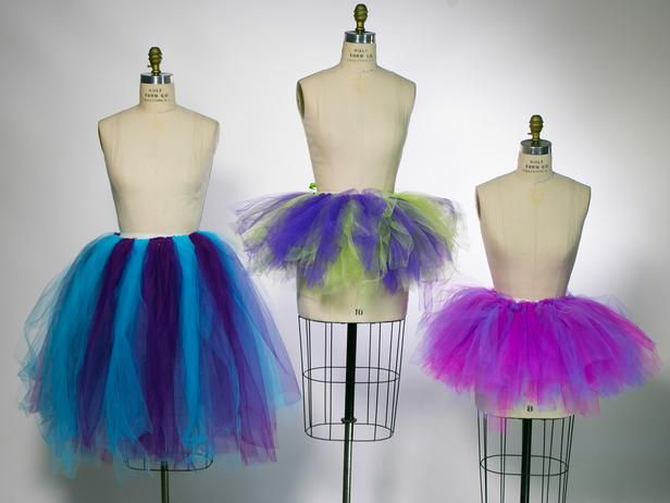 three mannequins with different colored tulle skirts