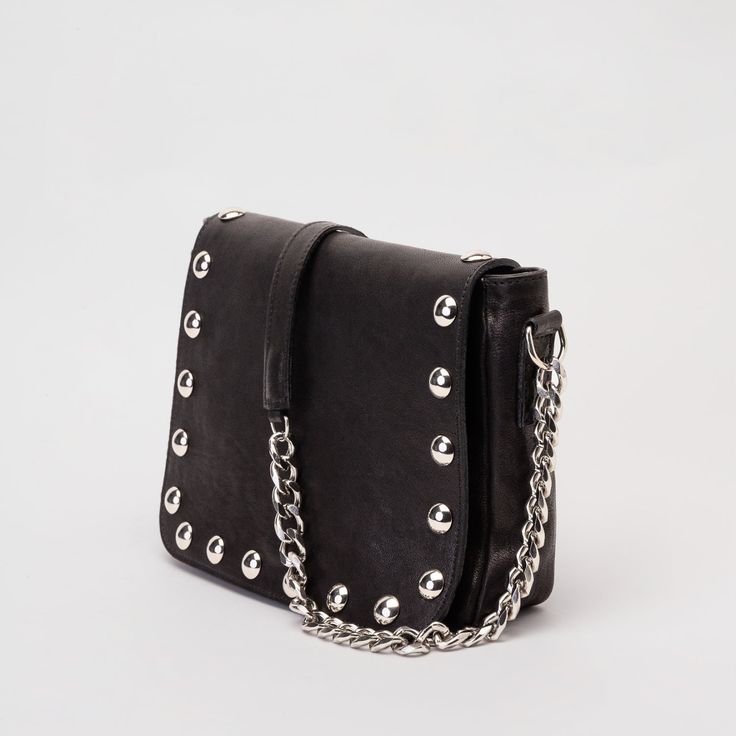 Black studded purse handmade in our atelier with vegetal-tanned leather and silver studs. You can wear this cool fold-over purse as a shoulder bag or crossbody bag thanks to its lightweight metallic chain, made with aluminum. It has a secure external zipped pocket hidden for the bag's flap. The inside of the bag is lined and has three pockets. Closure with magnetic clasp. An elegant and powerful black leather bag for going out and carrying your essentials. It is a handmade leather handbag. It do Elegant Bags With Rivets For Everyday Use, Chic Rectangular Bags With Rivets, Evening Crossbody Shoulder Bag With Rivets, Chic Leather Bags With Rivets, Leather Evening Bag With Rivets, Evening Crossbody Bags With Rivets, Chic Shoulder Bag With Rivets For Everyday Use, Evening Leather Bag With Rivets, Chic Everyday Shoulder Bag With Rivets