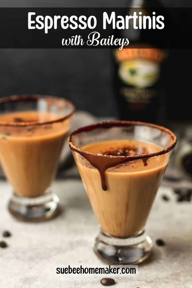 two glasses filled with espresso martinis sitting on top of a table