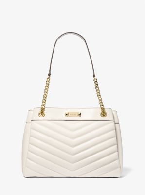 Meet the Whitney: a chic handbag crafted from quilted leather with smooth trim. Gilded hardware lends a luxe finish, while a pocketed interior will keep your everyday essentials organized. Take it with you from morning appointments to dinner plans—it will see you through it all. White Quilted Bag For Formal Occasions, Classic Quilted Tote Bag, Elegant White Quilted Bag, Classic Quilted Tote Shoulder Bag, Classic Quilted Travel Bag, Formal Quilted Double Handle Bags, Classic Quilted Shoulder Bag With Double Handle, Elegant Quilted Leather Bags, Classic Quilted Shoulder Bag For Shopping