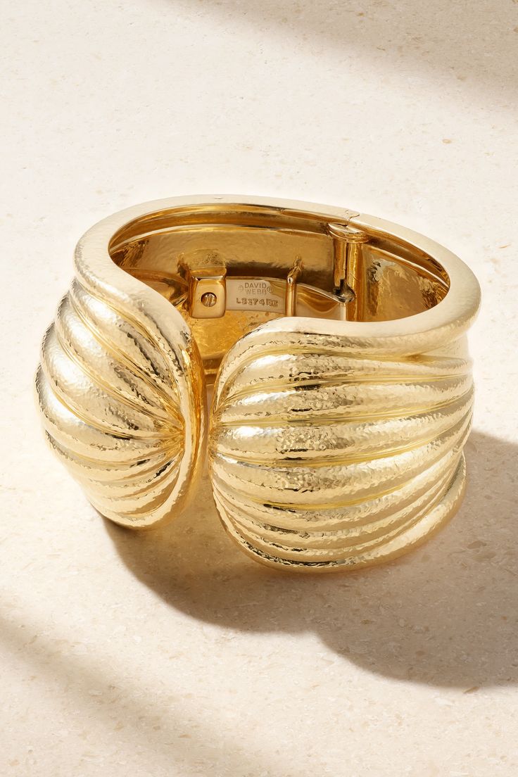 Since 1948, DAVID WEBB has remained one of the world's most renowned jewelry houses - the late founder's sculptural eye earned him honors like crafting The White House's official Gifts of State, appointed for the role by Jacqueline Kennedy. This cuff is handmade from 18-karat gold that's meticulously carved and hammered to resemble a scallop shell. Daniel Brush Jewelry, Unique Cuff Bangle For Formal Occasions, Unique Yellow Gold Cuff Bracelet For Formal Occasions, Formal Yellow Gold Cuff Bracelet, Gold-tone Bangle With Polished Finish For Formal Occasions, Gold-tone Polished Bangle For Formal Events, Gold-tone Polished Bangle For Formal Occasions, Luxury Gold Bangle Collectible, Yellow Gold Cuff Jewelry For Anniversary