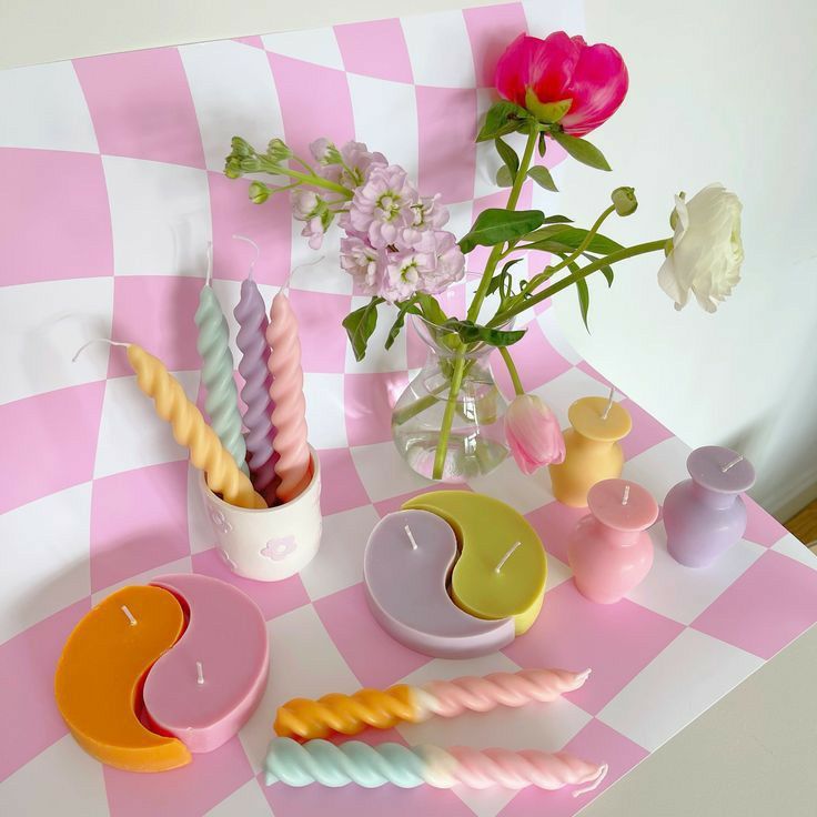 some candles and vases on a checkered table cloth