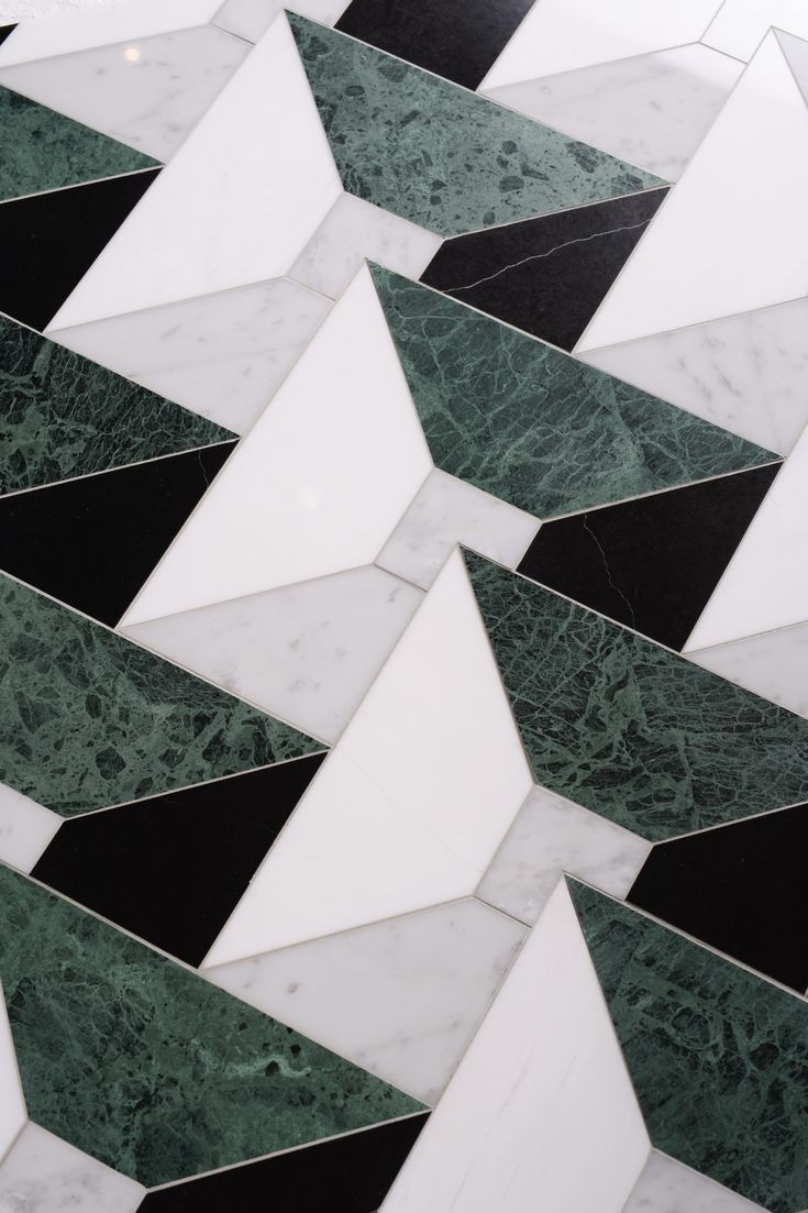 a marble floor with black and white tiles on it's sides, in the shape of an arrow