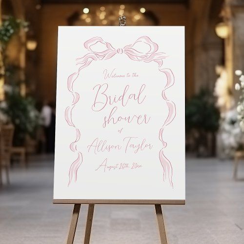 an easel with a sign on it in front of a building that says welcome to the bride and groom