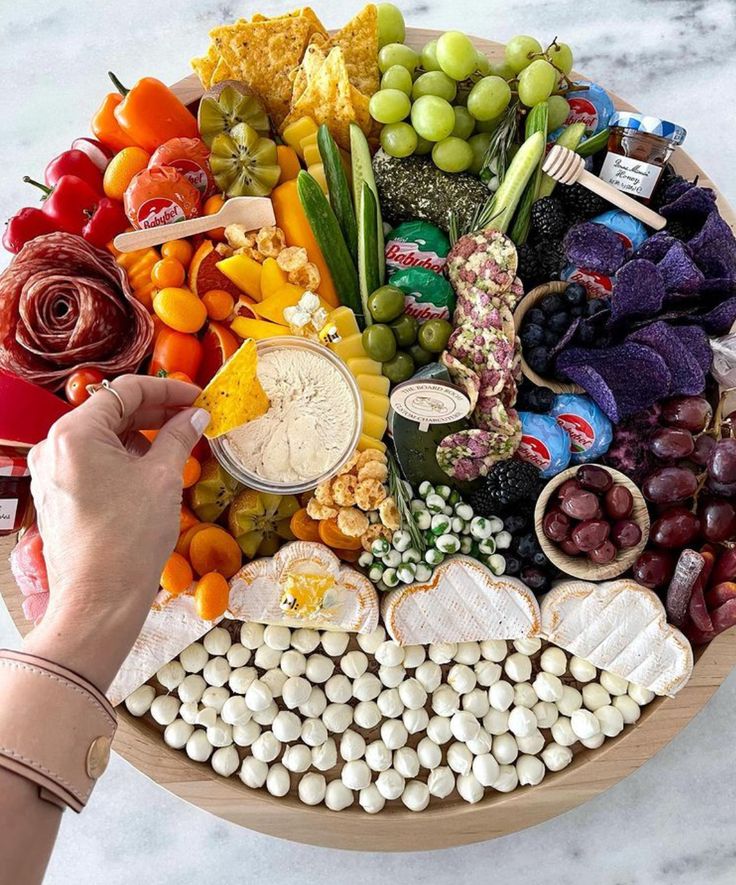 a platter filled with lots of different types of fruits and veggies on it