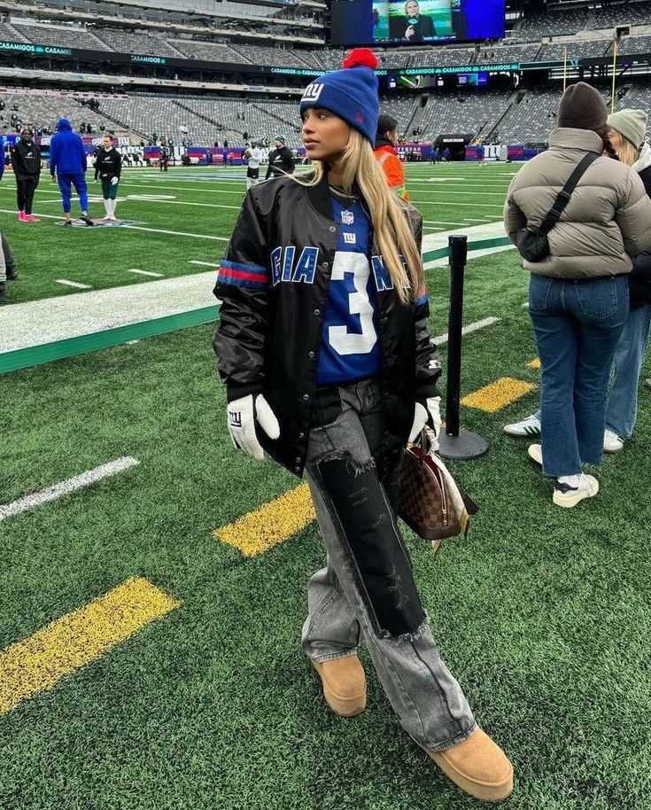 a woman standing on top of a football field