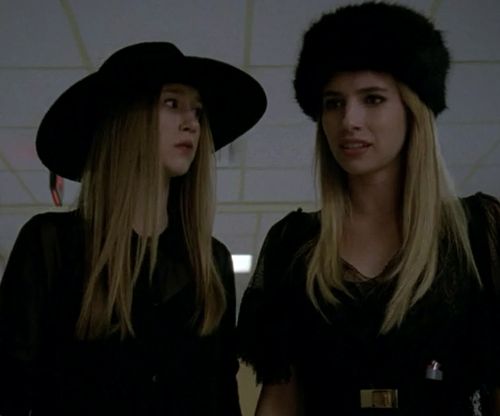 two women in black hats standing next to each other