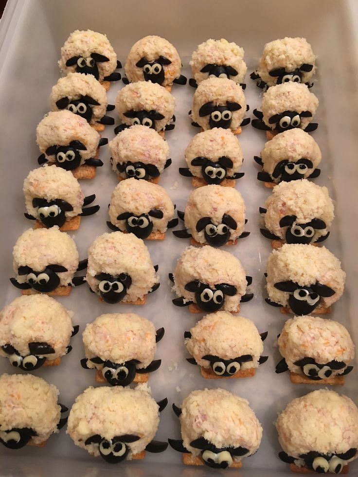 some cupcakes with black and white frosting in the shape of sheep