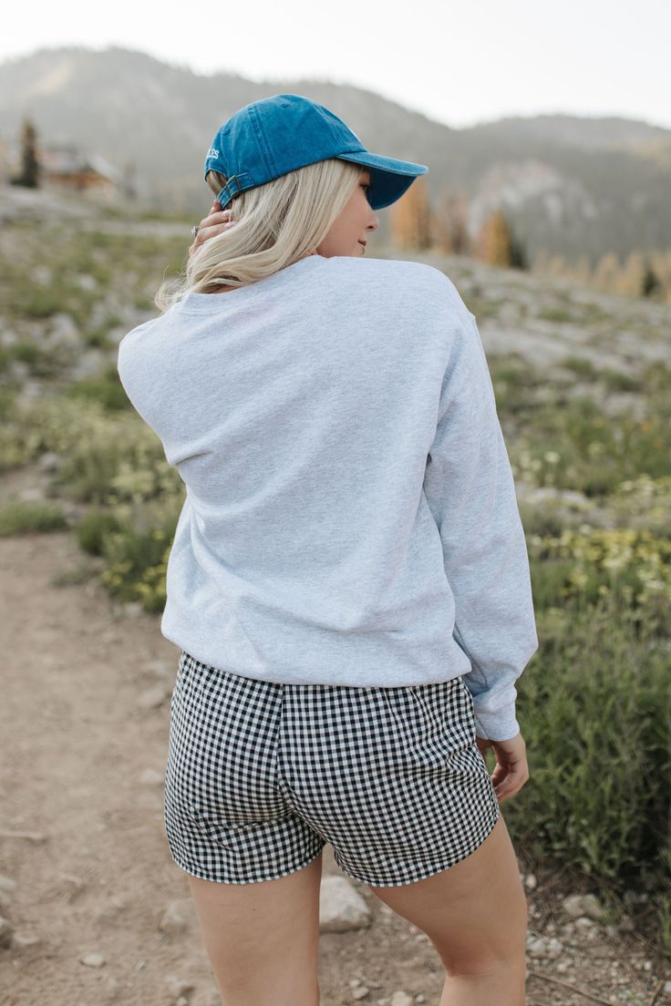 Go for a winning look with THE 98 SWEATSHIRT IN ASH. The oversized fit and grey fabric provide ultimate comfort, while the bold 98 graphic and red numbers give off a cool and sporty vibe. Perfect for both athletic and chic styles. Paired with THE MADA BOXER SHORTS IN BLACK AND WHITE GINGHAM and THE LOS ANGELES BASEBALL HAT IN ROYAL BLUE Oversized fit 98 graphic printed Premium cotton Unisex sizing 100% cotton Oversized fit. Small/Medium (0-6), Medium/Large (6-12) Model is 5'5" wearing a size sma