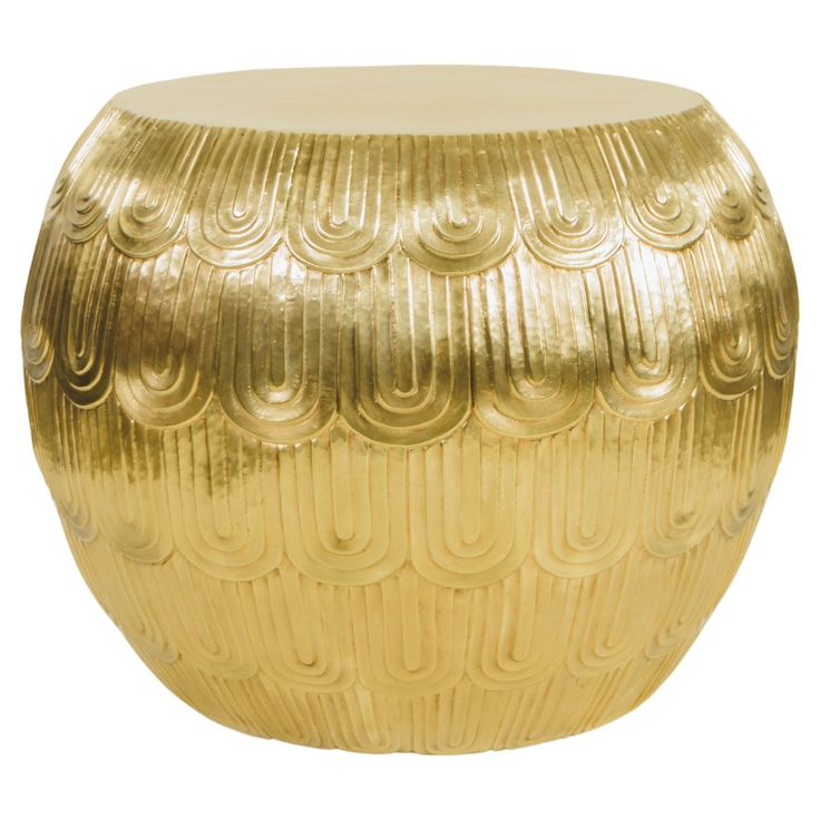 a gold colored stool with wavy designs on it