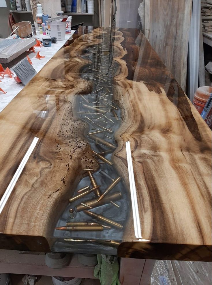 a long table made out of wood with nails sticking out of the top and holes in the middle