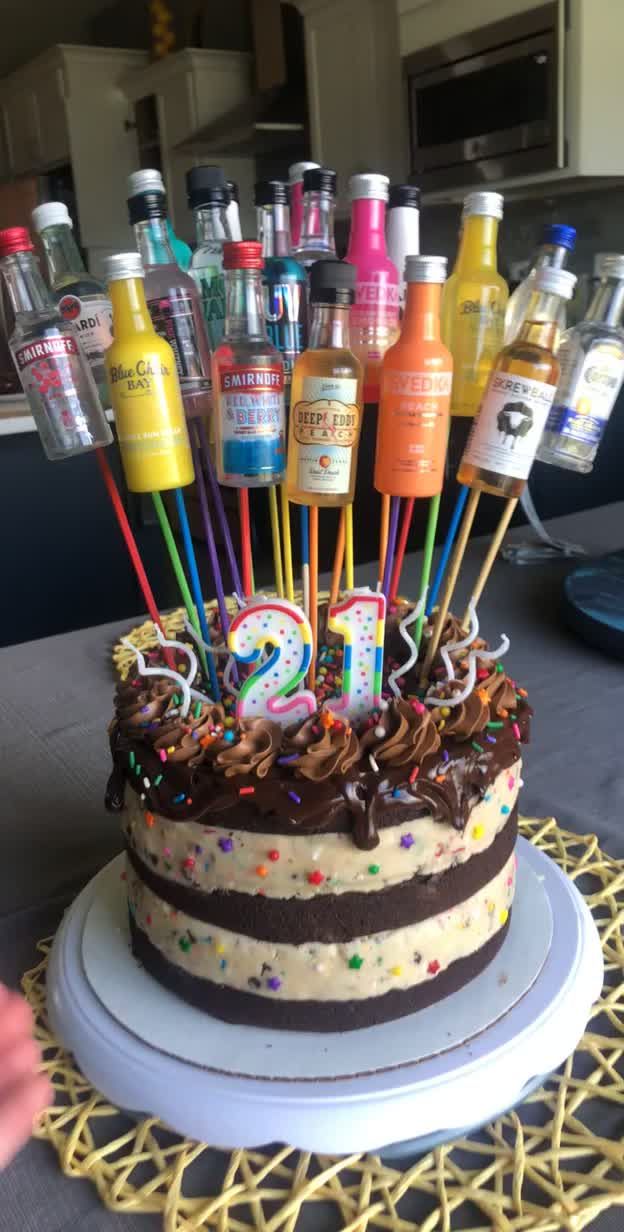 there is a cake with candles and bottles on it