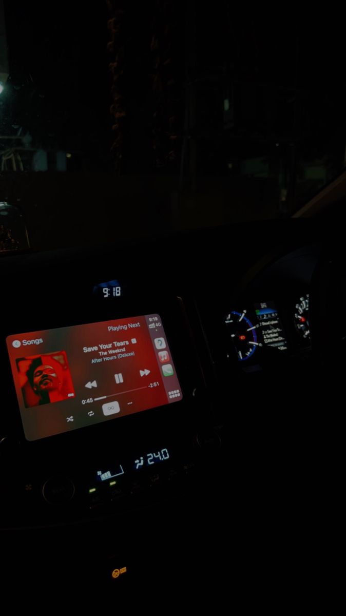 the dashboard of a car at night with an electronic screen on it's display