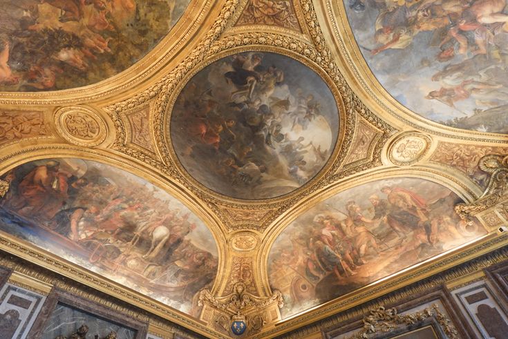 an ornate ceiling with many paintings on it