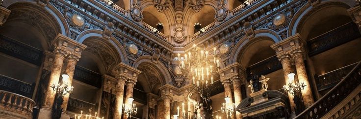 the interior of a large building with chandeliers