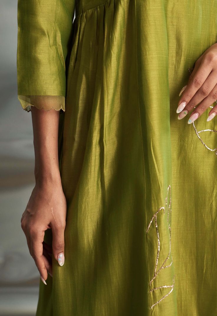 This berry green chanderi kurta boasts a light, flowing silhouette adorned with intricate nakshi handwork, offering a timeless appeal. The ensemble is elevated by a dreamy pure organza dupatta with additional nakshi handwork, while the flowy palazzo with scalloped edges adds a glamorous touch. The palazzo is elasticated and features a drawstring for comfort. Embroidered Floor-length Chanderi Palazzo Set, Embroidered Green Organza Kurta, Luxury Semi-stitched Organza Kurta, Semi-stitched Embroidered Organza Palazzo Set, Semi-stitched Green Organza Kurta, How To Hem Pants, Organza Dupatta, Satin Color, Scalloped Hem