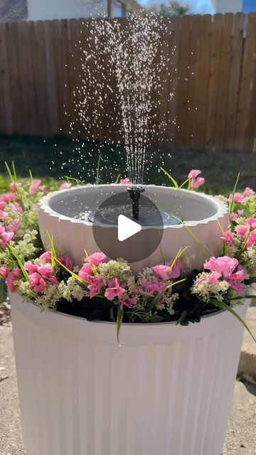 a flower pot filled with water and sprinkles in the middle of it