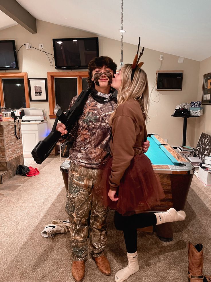 a man and woman standing next to each other in a room with a pool table