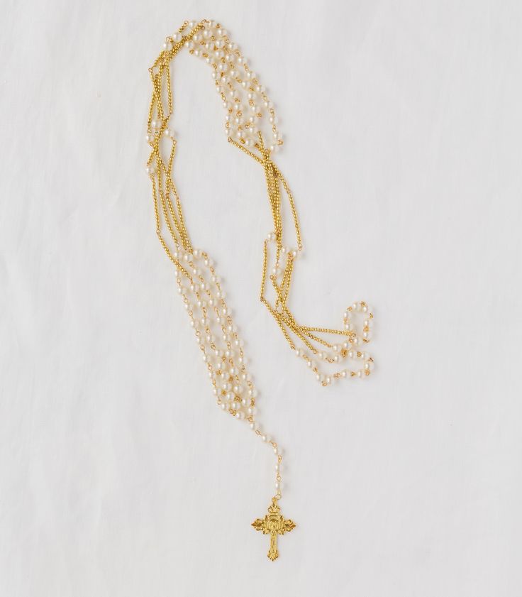 Also known as the Yugal, the Wedding Unity Cord is a traditional element of Filipino Catholic weddings rooted in the Rosary. Looped in an infinity symbol, the Unity Cord represents everlasting love and fidelity between a couple. Traditionally, using a Rosary-style Yugal reflects a union bound together before God. Pearls add a classic Filipiniana touch. Though the Yugal is conventionally a Catholic tradition, we encourage you to incorporate Filipino ceremony accessories into your wedding day, no Spiritual Gold Rosary For Wedding, Gold Wedding Rosary With Cross Shape, Gold Cross Rosary For Wedding, Elegant Gold Rosary For Anniversary, Elegant Cross Rosary For First Communion, Elegant Gold Anniversary Rosary, Wedding Spiritual Cross Rosary, Adjustable Cross Jewelry For Wedding, Elegant Silver Wedding Rosary