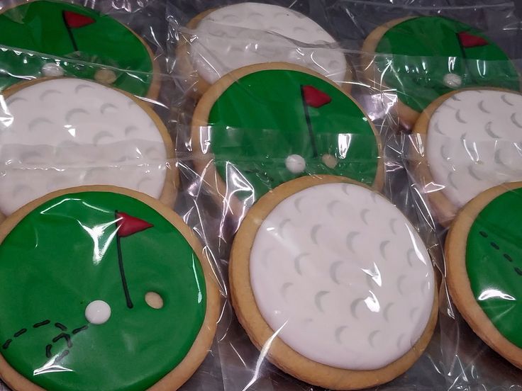 decorated cookies in the shape of golf balls and tees