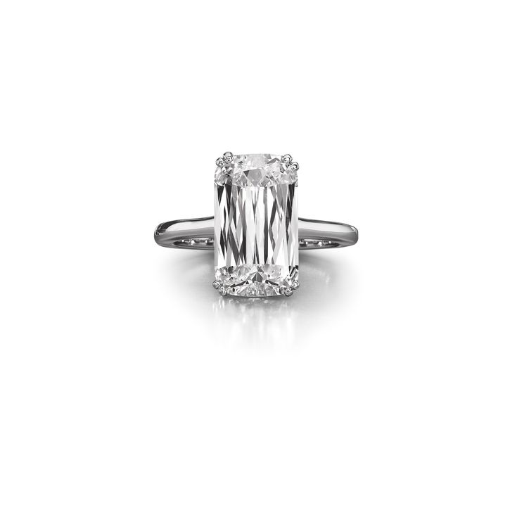 an emerald - cut diamond engagement ring on a white background