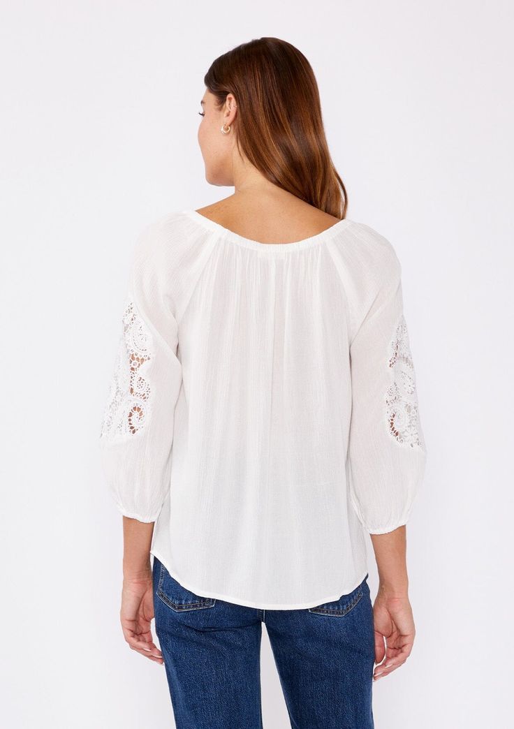 A casual bohemian blouse with a beautiful paisley lace detail on sleeve. Relaxed, flowy fit Elastic on or off-shoulder neckline 3/4 length sleeves Elastic wrist cuff Lace detail Flowy bohemian blouse Dry clean recommended or hand wash cold Step into effortless bohemian chic with this versatile blouse, beautifully designed with intricate paisley lace detailing. The relaxed fit effortlessly flatters any figure, while the elastic round neckline offers different styling options. Wear it as-is for a Casual Rayon Tops With Lace Trim, Chic Blouse With Lace Trim And 3/4 Sleeves, Casual Blouse With Lace Sleeves For Brunch, Casual Tops With Lace Trim And 3/4 Sleeve, Bohemian Long Sleeve Off-shoulder Top, Bohemian Off-shoulder Long Sleeve Top, Casual Blouse With Lace Sleeves For Spring, Bohemian Long Sleeve Off-shoulder Top For Vacation, Summer Blouse With Lace Cuffs